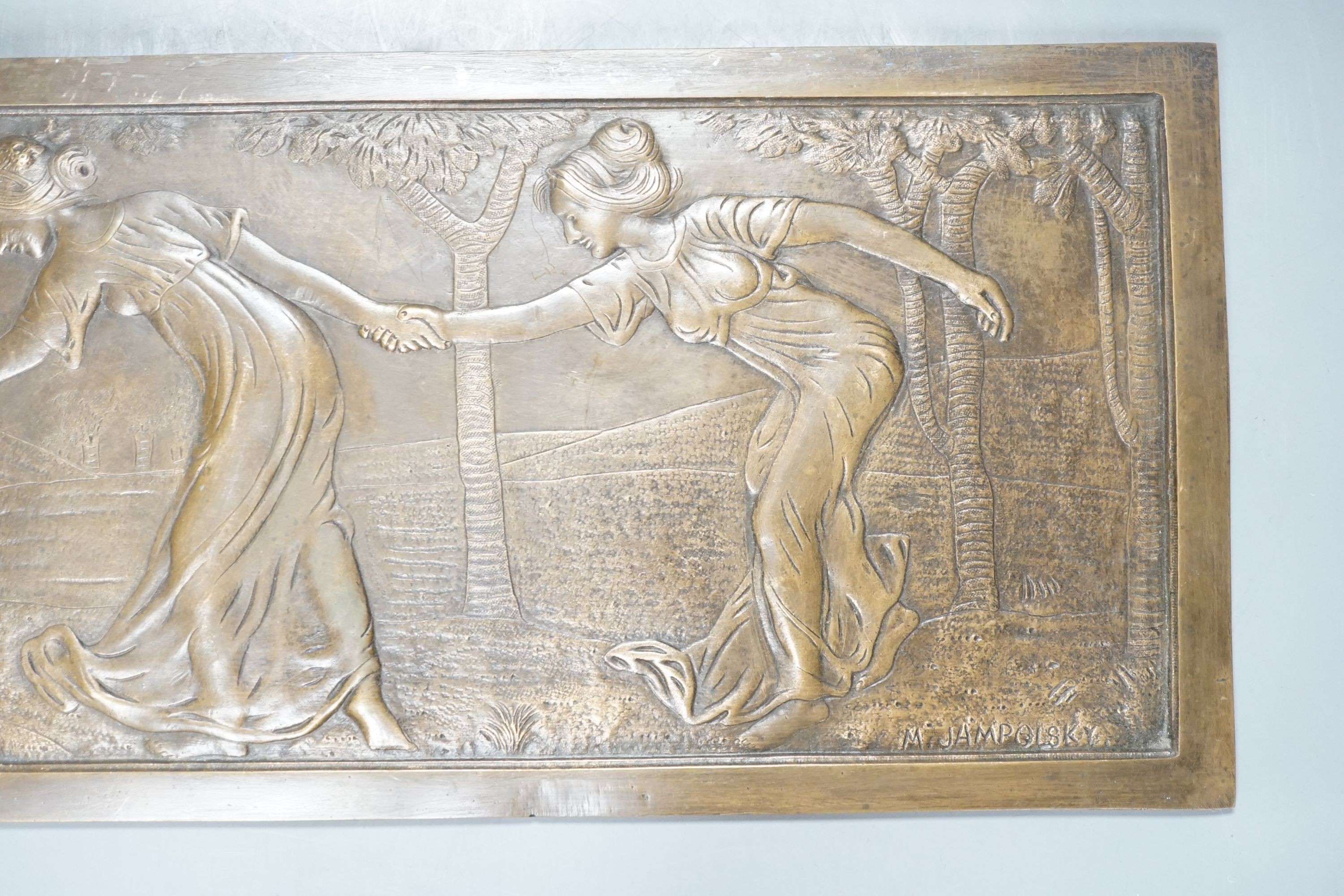 A signed M Jampolsky, Art Nouveau rectangular figural bronze plaque, 36.5 cms wide x 8 cms high.